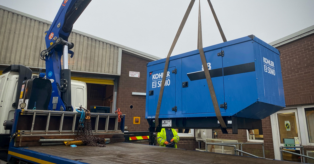 Standby generator being loaded into position at customer site ready for install and commissioning