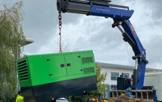 Green generator being relocated.