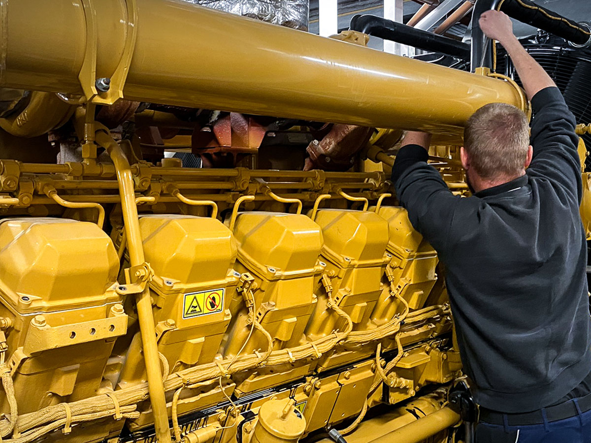 A generator engineer carrying out a full service as part of planned maintenance.