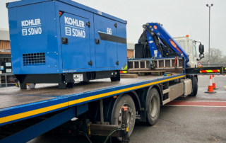Generator on a flatbed trailer ready to be offloaded and installed at a motorway depot