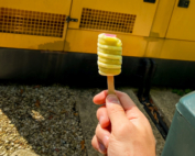 Twister ice lolly raised in front of a yellow generator